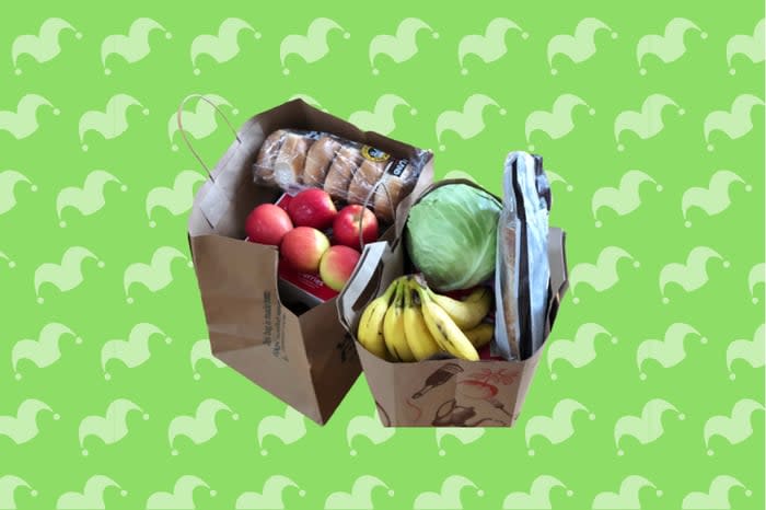 Two full grocery bags on top of a green background