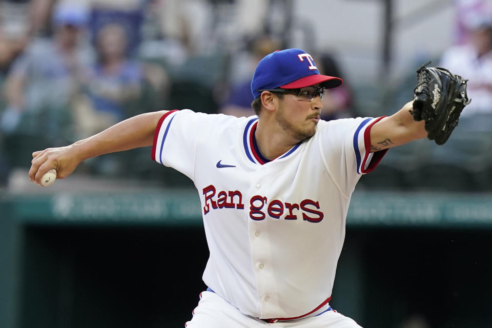 Texas Rangers starting pitcher Dane Dunning throws during the first inning of the team's baseball game against the Atlanta Braves in Arlington, Texas, Saturday, April 30, 2022. (AP Photo/LM Otero)