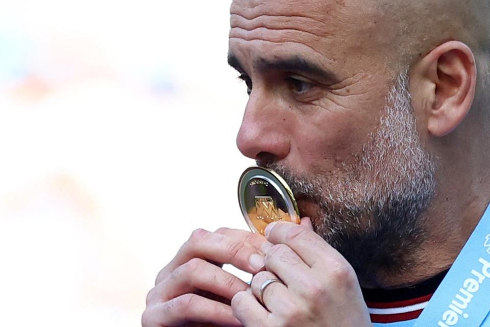 Pep Guardiola with his Premier League winners’ medal (REUTERS)