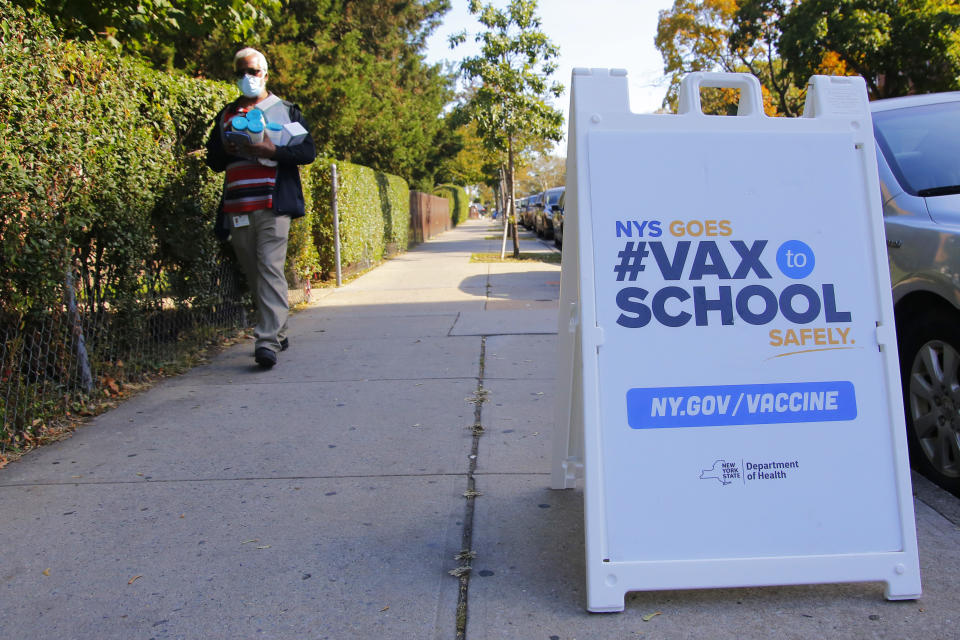 A man walks past a sign announcing a #VaxtoSchool pop-up site at Life of Hope Center on October 21, 2021 in New York City. (Michael M. Santiago/Getty Images)