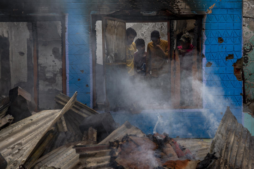 Smoke rises from the debris of a house destroyed in a gunfight in Pulwama, south of Srinagar, Indian controlled Kashmir, Wednesday, July 14, 2021. Three suspected rebels were killed in a gunfight in Indian-controlled Kashmir on Wednesday, officials said, as violence in the disputed region increased in recent weeks. Two residential houses were also destroyed. (AP Photo/ Dar Yasin)