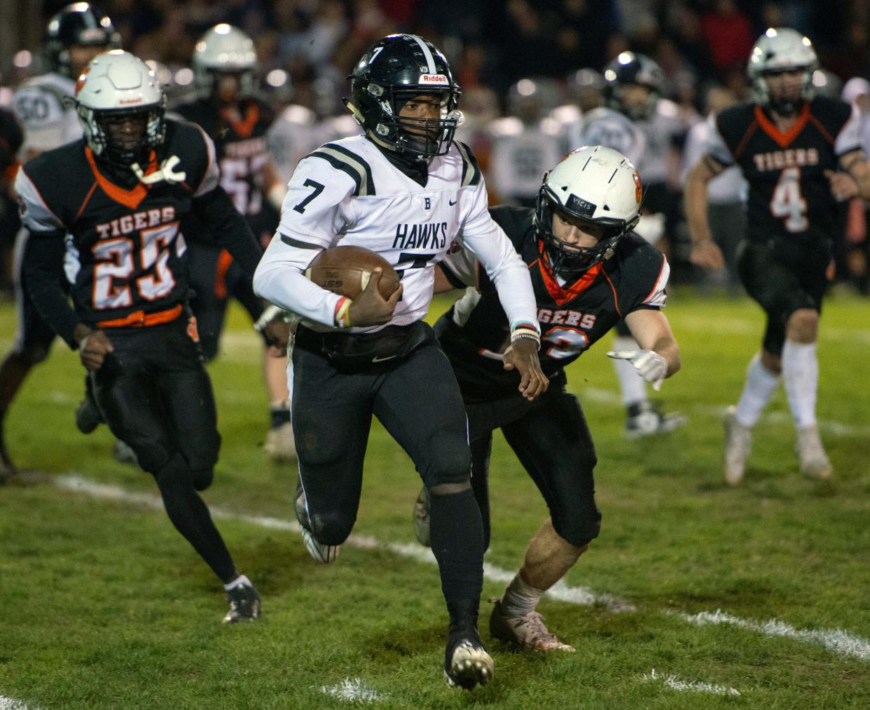 Bellingham senior captain and quarterback Dasha Domercant runs the ball during the Division 6 Sweet 16 game at Alumni Field in Maynard, Nov. 3, 2023. The Blackhawks defeated the Tigers, 28-21.