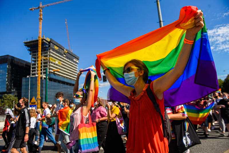 A supporter wears a protective face mask, holding a rainbow flag during the march. LGBT supporters participate in the 4th Edition of the Equality Parade in Katowice, guarded by hundreds of police officers and attracting more than 1500 participants.