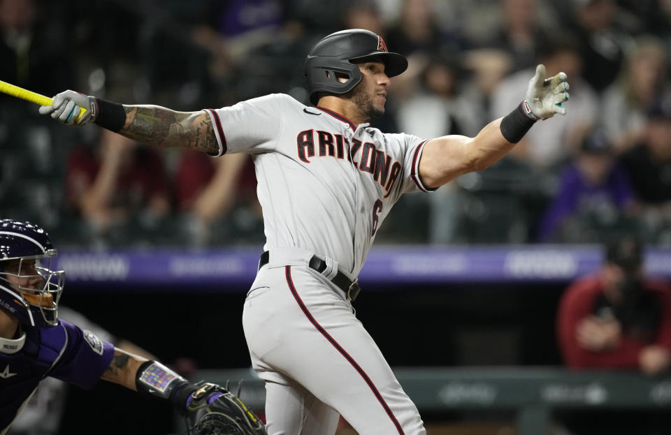 Arizona Diamondbacks' David Peralta follows the flight of his single off Colorado Rockies relief pitcher Jordan Sheffield in the eighth inning of a baseball game Friday, May 21, 2021, in Denver. (AP Photo/David Zalubowski)