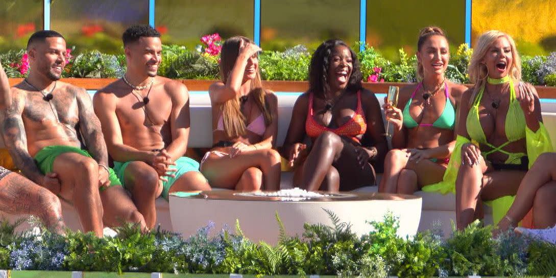 toby, mitchel, chris, jake, luis, anton, liberty, georgia harrison, demi, kaz, hannah, georgia steel sit together laughing during love island all stars, day 1