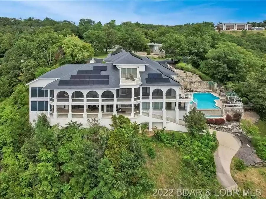 large house with a pool surrounded by trees in Missouri