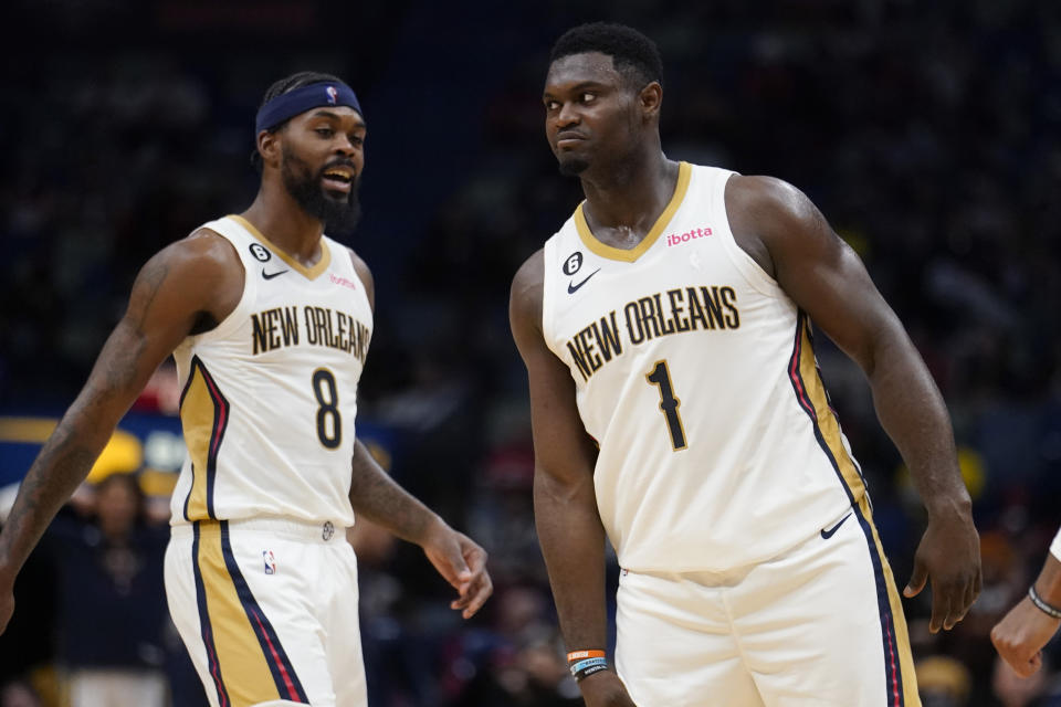 New Orleans Pelicans forward Zion Williamson (1) reacts with forward Naji Marshall (8) after being fouled in the act of scoring a basket in the second half of an NBA preseason basketball game against the Detroit Pistons in New Orleans, Friday, Oct. 7, 2022. The Pelicans won 107-101. (AP Photo/Gerald Herbert)