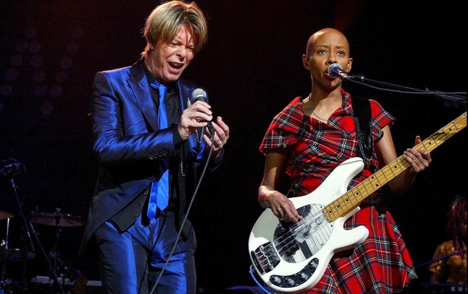 David Bowie (left) and Gail Ann Dorsey perform at the Paris Zenith on September 25, 2002