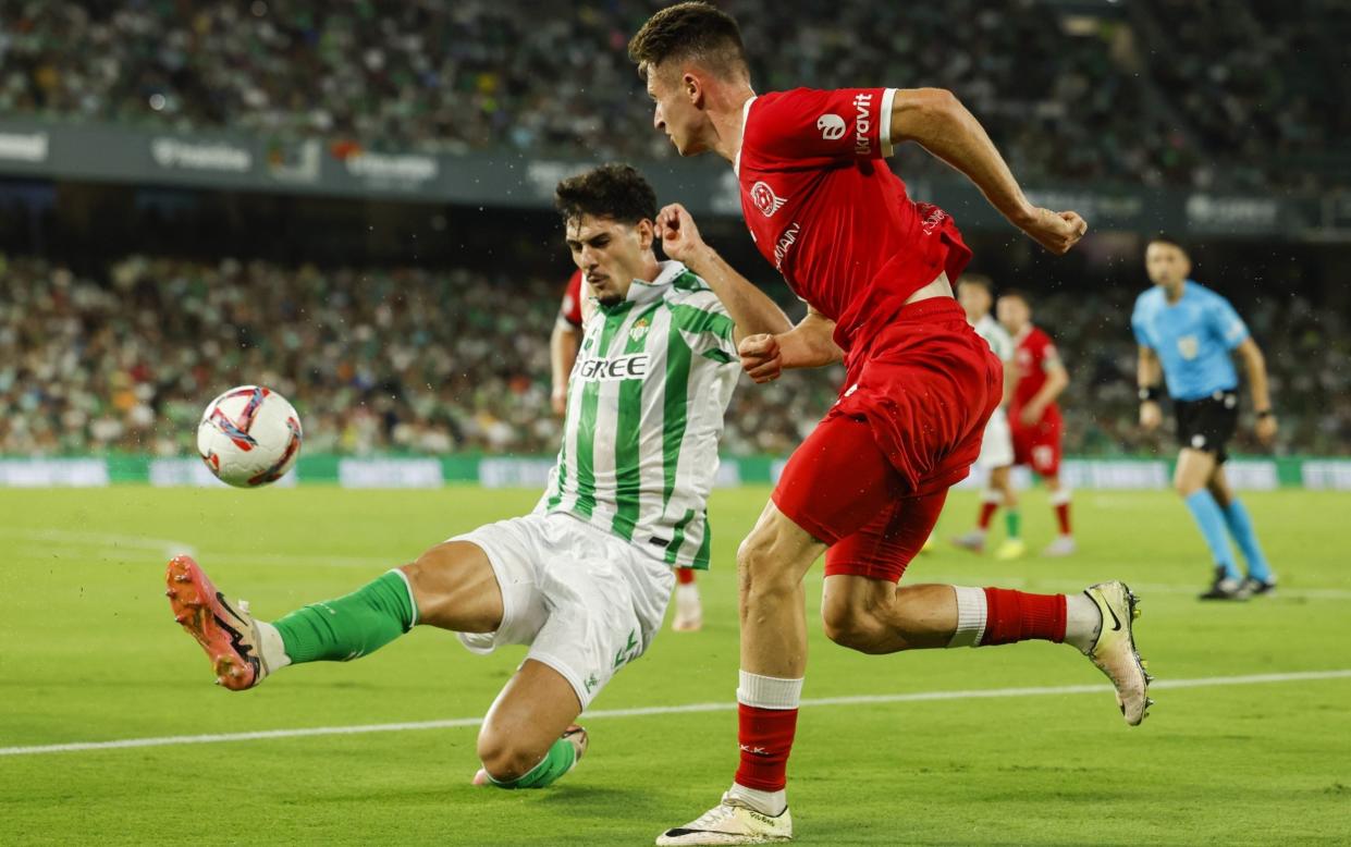 Real Betis's Johnny Cardoso (left) fights for possession with Oleksandr Drambayev of Kryvbas Kryvyi Rih/Tottenham 'pre-order' US international Johnny Cardoso with £21m clause in Real Betis deal