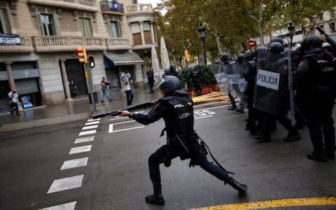 Spanish riot police shoot rubber bullets in Barcelona  - Credit: AP Photo/Emilio Morenatti