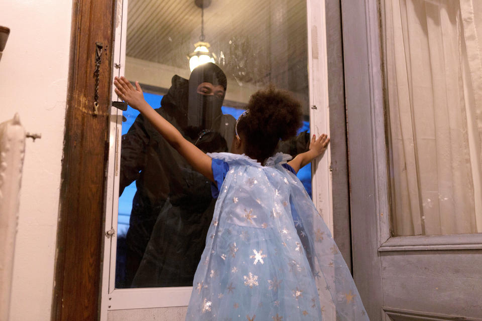 Hashim, an essential worker in the healthcare industry, speaks to his daughter through the closed door as he maintains social distance from his family as he works amid the coronavirus disease (COVID-19) outbreak in New Rochelle, New York, U.S., April 20, 2020. Picture taken April 20, 2020.  REUTERS/Joy Malone     TPX IMAGES OF THE DAY