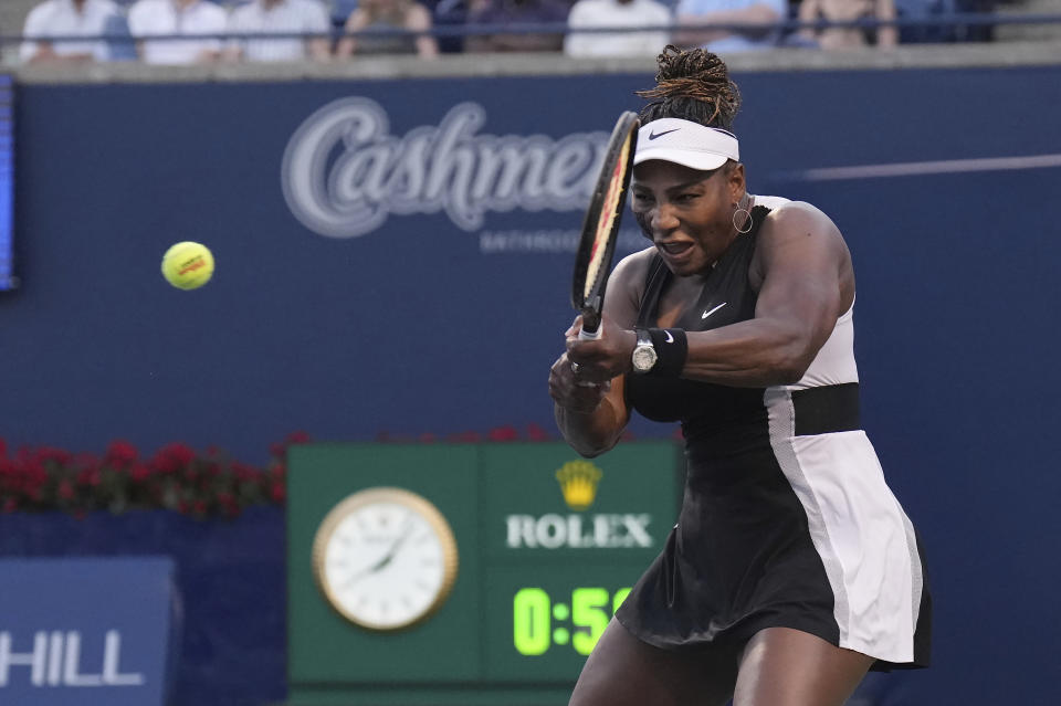 Serena Williams, of the United States, his a backhand to Belinda Bencic, of Switzerland, during the National Bank Open tennis tournament Wednesday, Aug. 10, 2022, in Toronto. (Nathan Denette/The Canadian Press via AP)