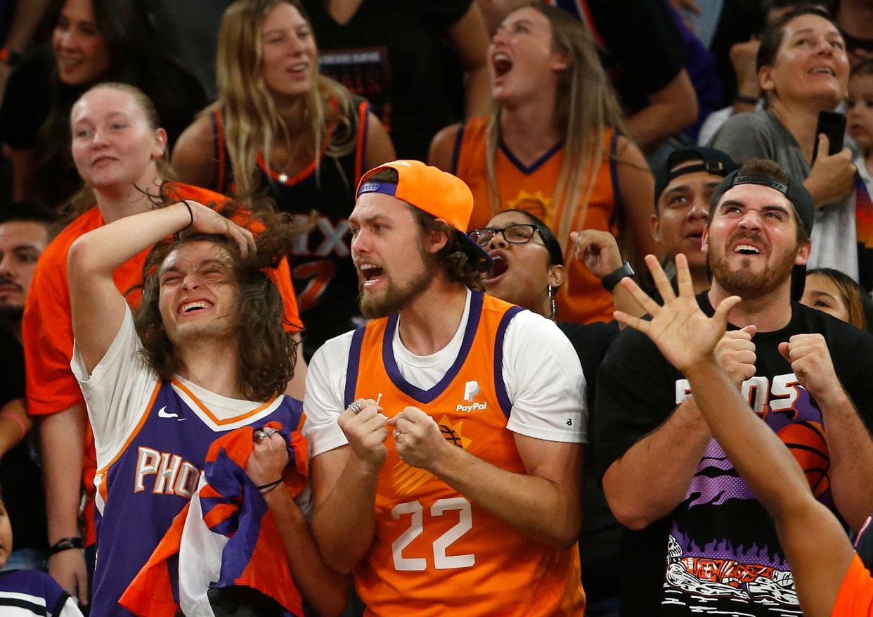 Fans react as they watch the jumbotron during a Suns Road Rally watch party for Game 6 of the NBA Finals at the Footprint Center in Phoenix, July 20, 2021.