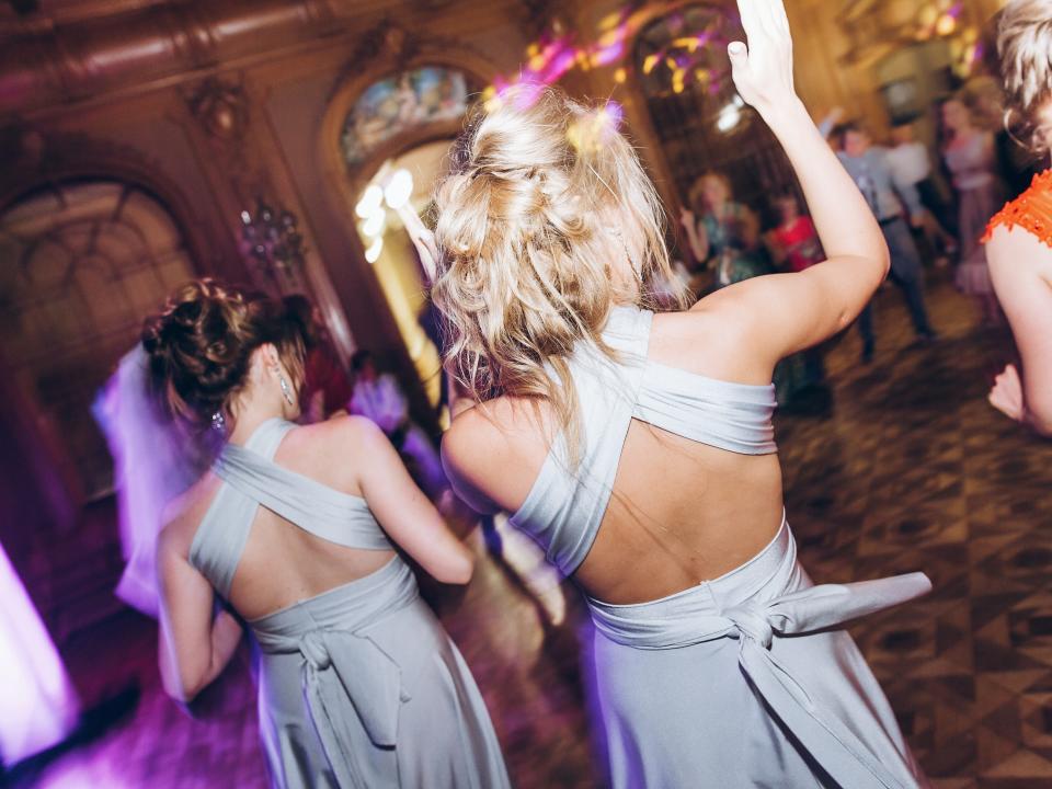 bridesmaids dancing on the dance floor at a wedding