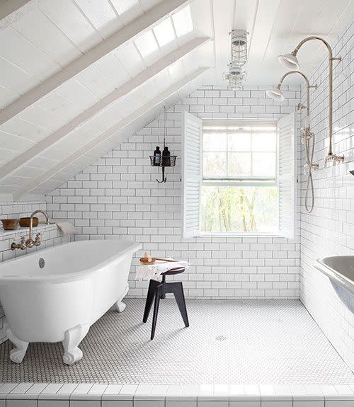 <p>In the bathroom of this in this <a href="https://www.countryliving.com/remodeling-renovation/home-makeovers/g1505/pennsylvania-diy-home-renovation/#" rel="nofollow noopener" target="_blank" data-ylk="slk:Pennsylvania home;elm:context_link;itc:0;sec:content-canvas" class="link ">Pennsylvania home</a>, a Victoria + Albert tub sits opposite the showers, all finished with fittings from Habitat, a local hardware store. The hanging basket, once used by miners, holds toiletries.</p>