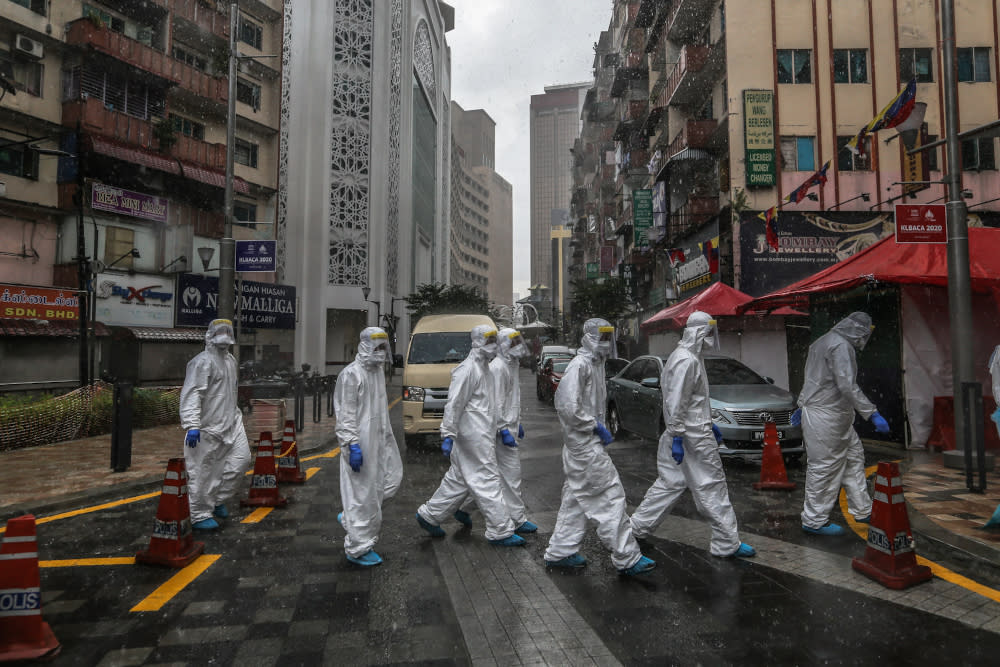 Health workers in protective suits are seen at Selangor Mansion in Jalan Masjid India April 6, 2020. — Picture by Firdaus Latif