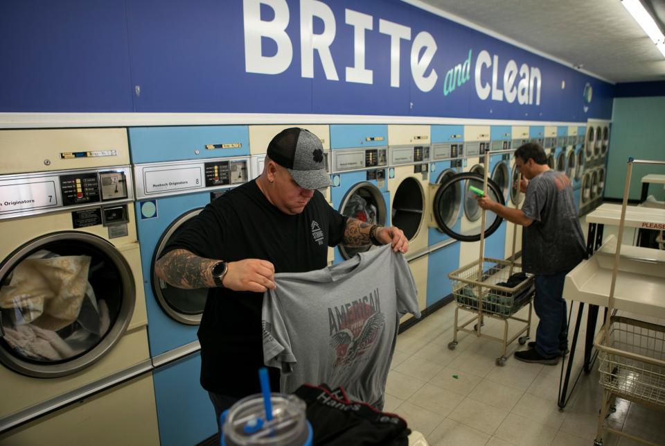 Michael Mick, of Chillicothe, folds his laundry inside of Brite and Clean Laundromat on September 8, 2023, in Chillicothe, Ohio.