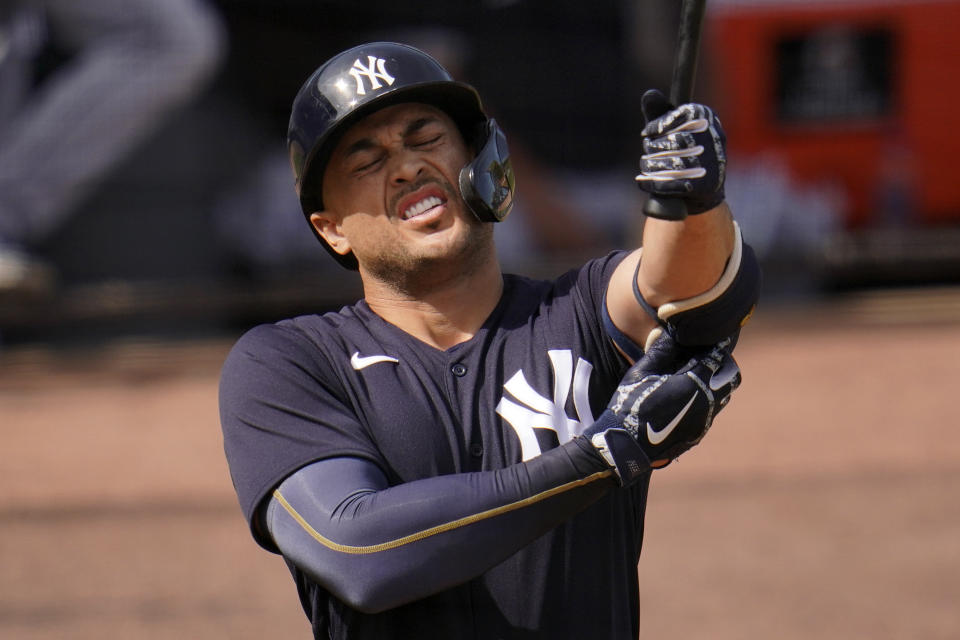 New York Yankees' Giancarlo Stanton adjusts his elbow pad during an at-bat in the fifth inning of a spring training exhibition baseball game against the Detroit Tigers at George M. Steinbrenner Field in Tampa, Fla., Friday, March 5, 2021. (AP Photo/Gene J. Puskar)