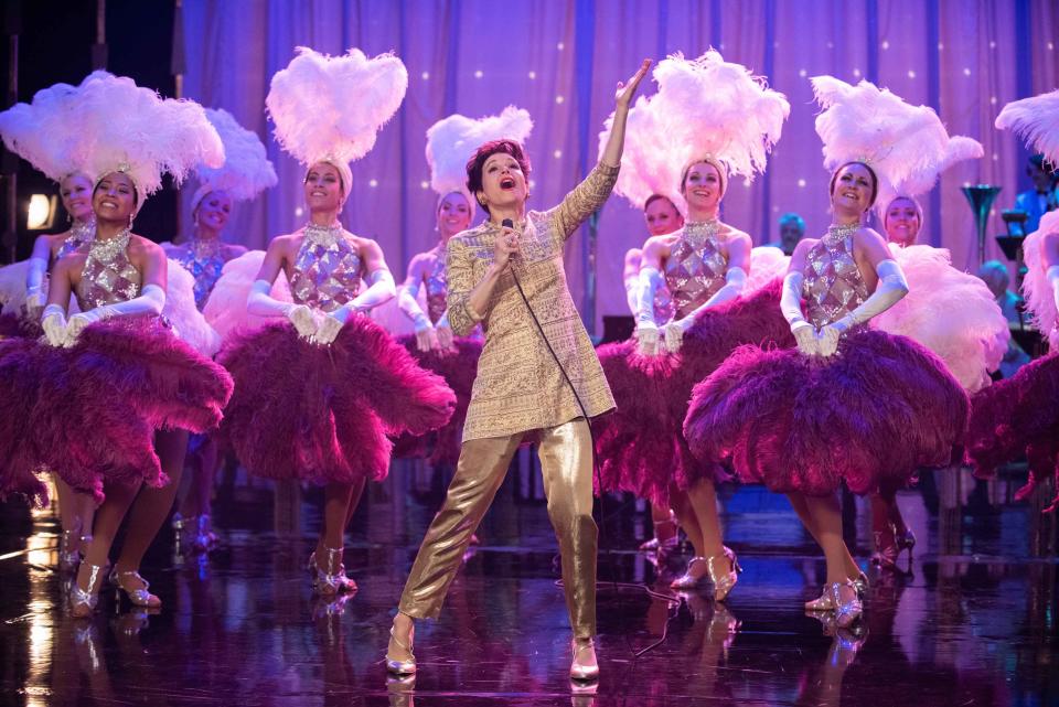 Judy Garland (Renee Zellweger) is a showstopper with colorful backup dancers in 