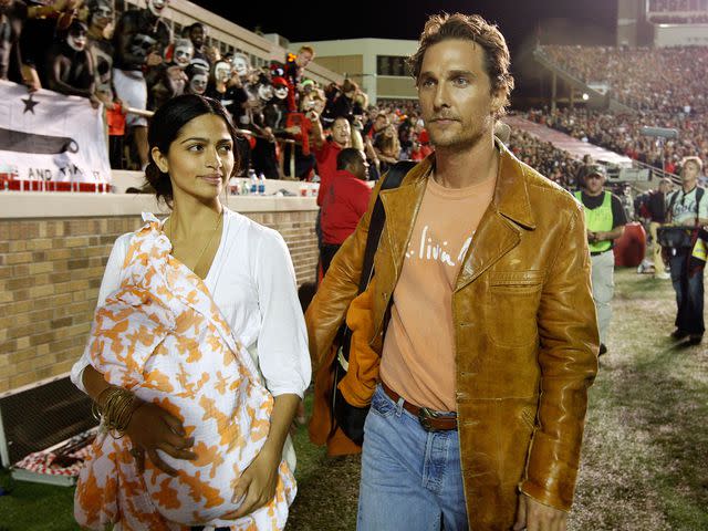 <p>Jamie Squire/Getty </p> Matthew McConaughey and Camila Alves McConaughey walk the sidelines with their baby Levi during the game between the Texas Longhorns and the Texas Tech Red Raiders on Nov. 1, 2008.
