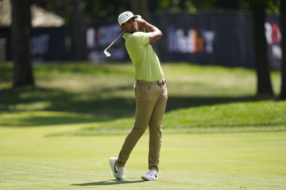 Tony Finau hits his second shot onto the seventh green during the final round of the Rocket Mortgage Classic golf tournament, Sunday, July 31, 2022, in Detroit. (AP Photo/Carlos Osorio)