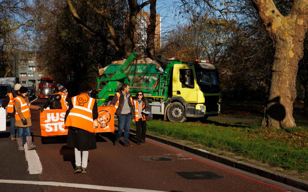 Driver of a skip lorry takes a detour through Stoke Newington Common to get around a Just Stop Oil blockade - Jamie Lorriman