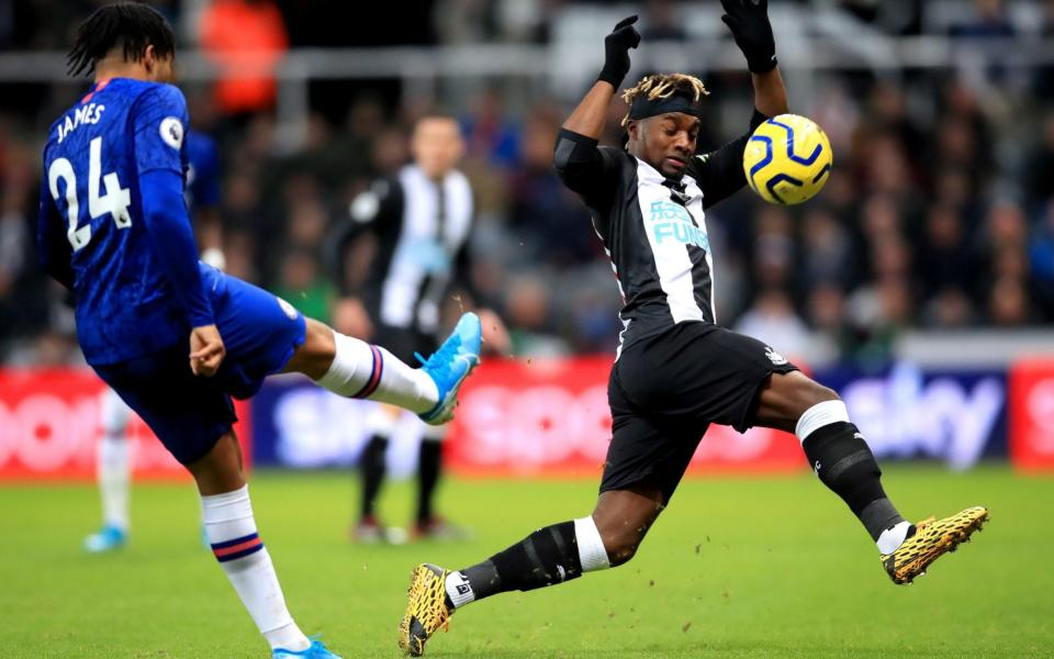 Chelsea's Reece James (left) and Newcastle United's Allan Saint-Maximin battle for the ball during the Premier League match at St James' Park - PA