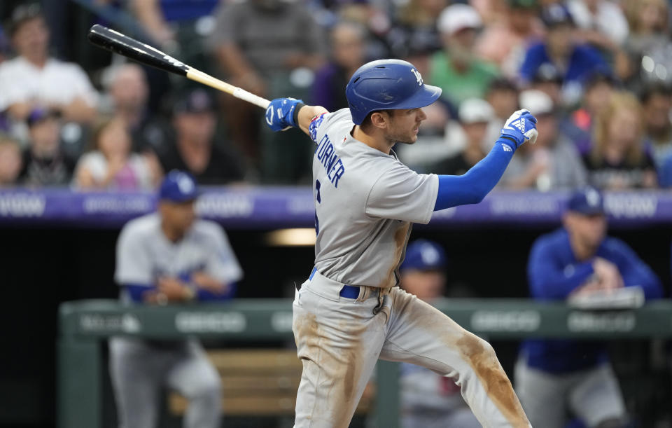 Los Angeles Dodgers' Trea Turner watches his three-run double off Colorado Rockies starting pitcher Jose Urena during the second inning of a baseball game Thursday, July 28, 2022, in Denver. (AP Photo/David Zalubowski)