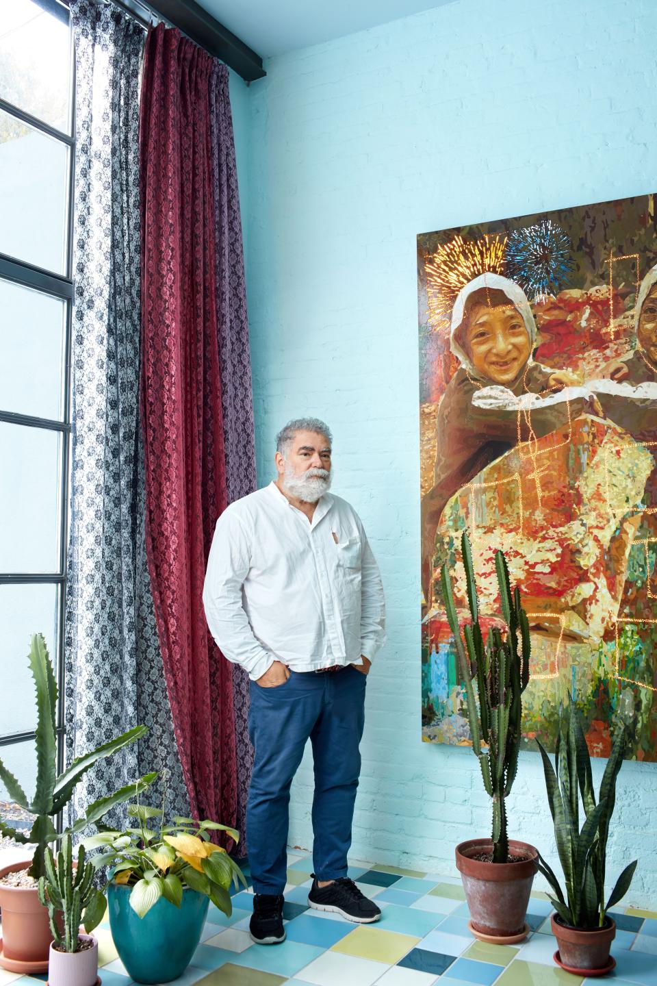 The artist and his painting in the living area.