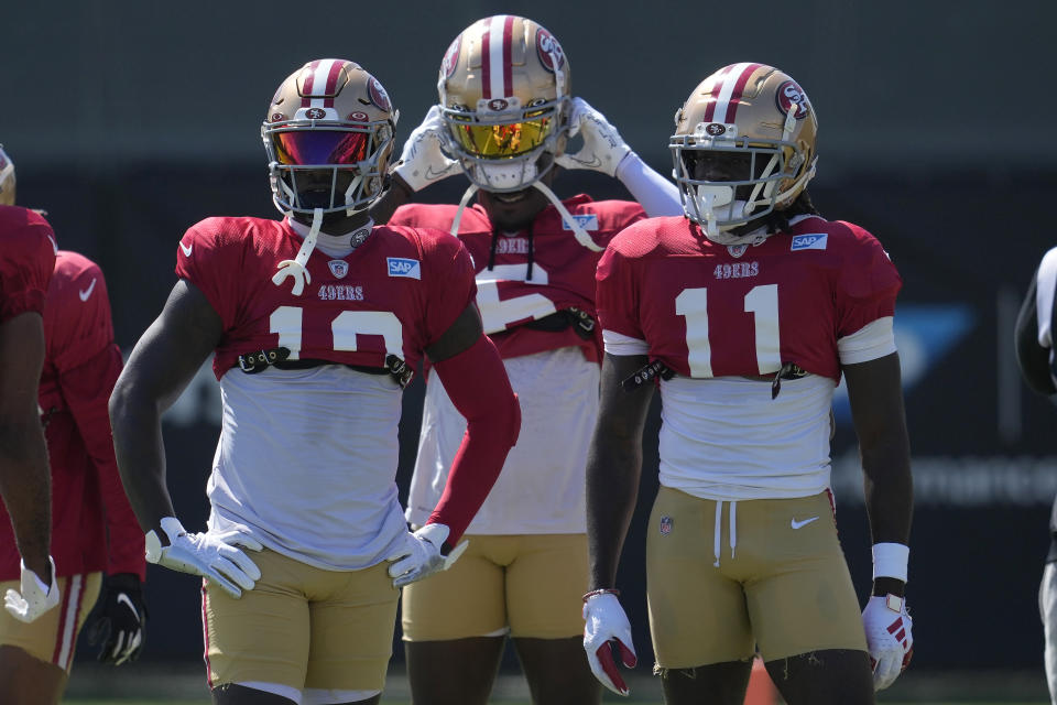 San Francisco 49ers wide receivers Deebo Samuel, left, Danny Gray, middle, and Brandon Aiyuk (11) take part in drills during the NFL team's football training camp in Santa Clara, Calif., Tuesday, Aug. 1, 2023. (AP Photo/Jeff Chiu)