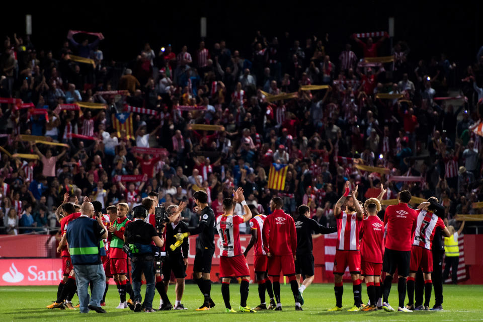 Girona players and fans celebrate their memorable victory over Real Madrid. (Getty)