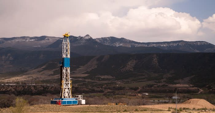 Drilling rig with mountains in the background.