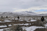 This photo provided by The National Transportation Safety Board shows NTSB investigators conducting a grid search on Sunday, Feb. 26, 2023, near the wreckage of a Pilatus PC-12 airplane that crashed in Dayton, Nev. The medical air transport flight operated by Guardian Flight crashed on Friday, Feb. 24, while enroute from Reno, Nevada, to Salt Lake City. (NTSB via AP)