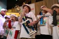 Connor Slocombe, from Eagle River, Alaska, holds his trophy with other contestants after winning Odor-Eater's Rotten Sneaker Contest at Ripley's Believe It or Not! in Times Square in New York, U.S., March 28, 2017. REUTERS/Shannon Stapleton