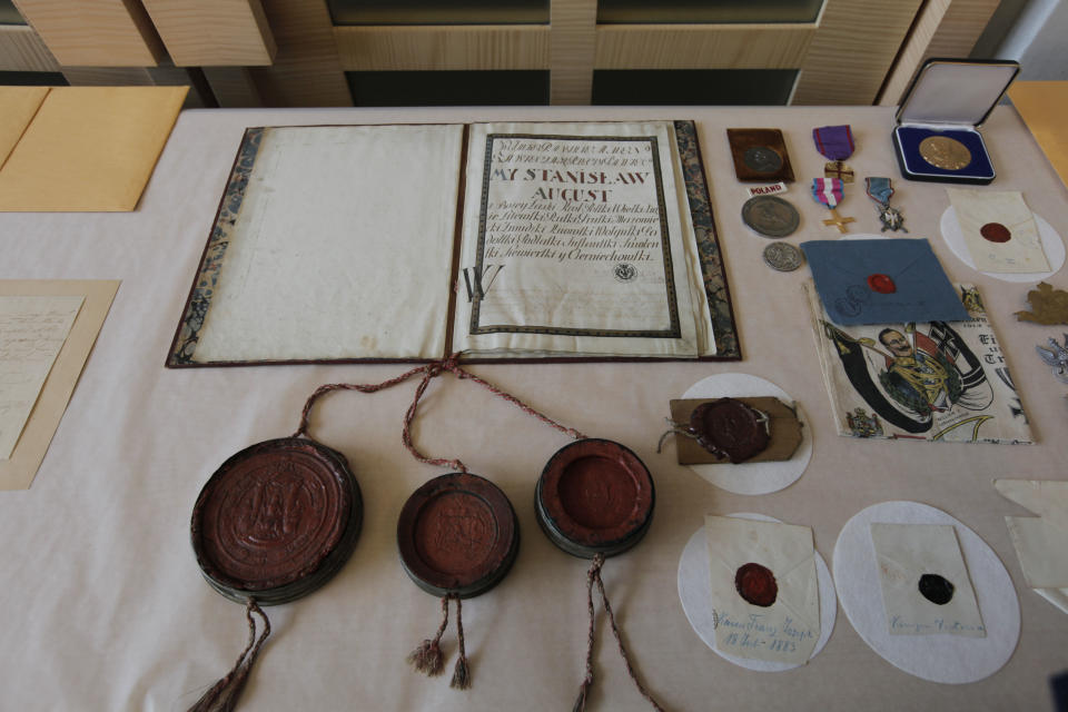 This photo taken Wednesday, June 20, 2012, at FBI Headquarters in Chicago, shows some of the more than 120 stolen artifacts missing for decades from the Chicago Polish Museum of America _ including letters with the signatures of Abraham Lincoln, Thomas Jefferson and American Revolution hero Thaddeus Kosciuszko that were returned to the Museum by the FBI on Wednesday. The items include letters and documents dating to the 18th and 19th centuries, seals, military medals and Nazi propaganda from World War II. The pieces, which the FBI valued at about $5 million, also included documentation about Napoleon, George Washington, John Adams and Polish kings. (AP Photo/M. Spencer Green)