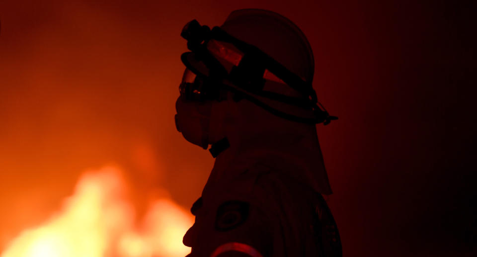 A fire fighter observing a NSW bushfire during the Black Summer Bushfires