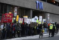 Police watch as protesters gather outside a local television station prior to the arrival of the leaders of Quebec's political parties for the second debate in Montreal, March 27, 2014. Quebec voters will go to the polls in a provincial election on April 7. REUTERS/Christinne Muschi (CANADA - Tags: POLITICS)