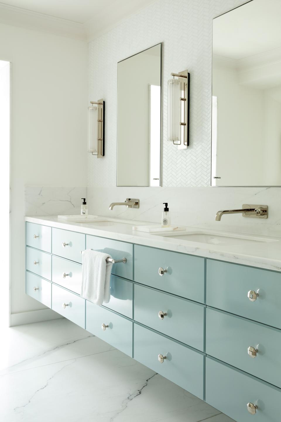 The high-gloss bathroom was designed by LyonsKelly with cabinetwork from Abington Design House. The lights are from Jonathan Coles while the quartzite marble was sourced from Miller Brothers.