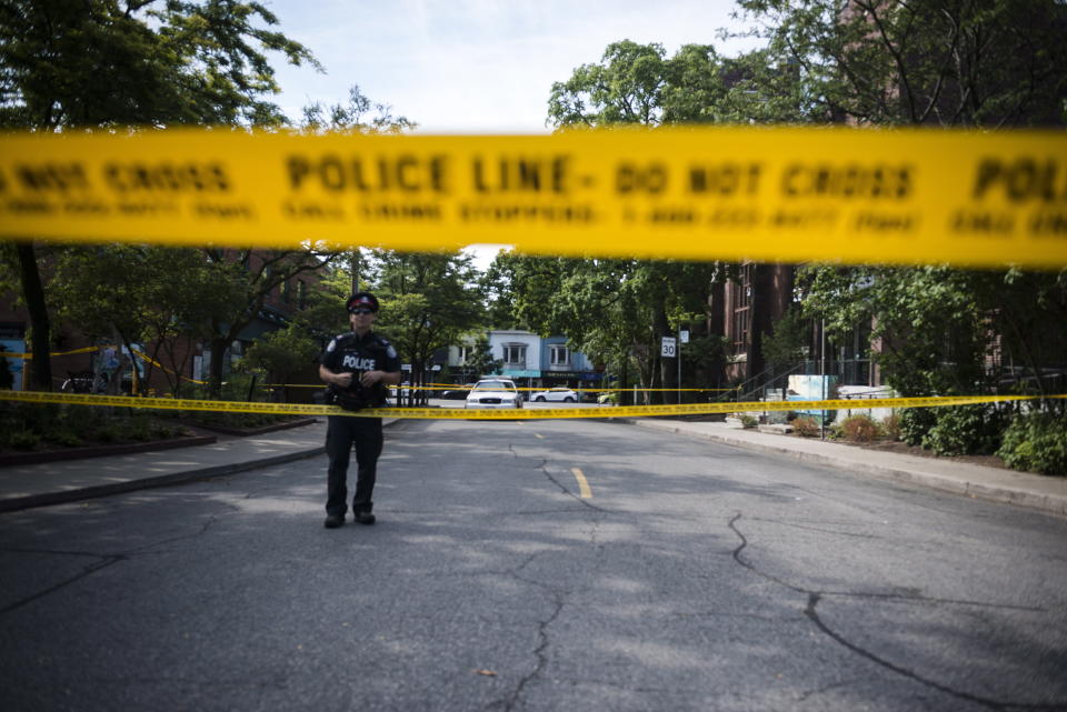 <p>Police are photographed at the perimeter of the scene of a mass shooting in Toronto on July 23, 2018. (Photo: Christopher Katsarov/The Canadian Press via AP) </p>