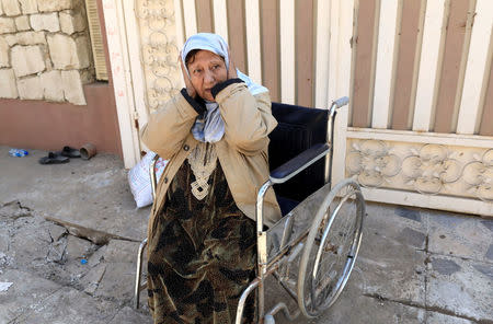 An Iraqi woman, who was left behind by her family, reacts while hearing shooting from helicopter, as Iraqi forces battle with Islamic State militants, in western Mosul, Iraq March 9, 2017. REUTERS/Zohra Bensemra