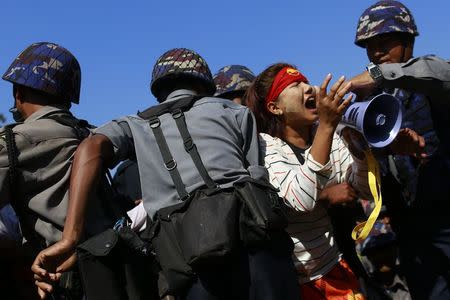 Police restrain student Ei Thinzar Maung during a protest against an education bill in Letpadan, Bago division March 6, 2015. REUTERS/Soe Zeya Tun