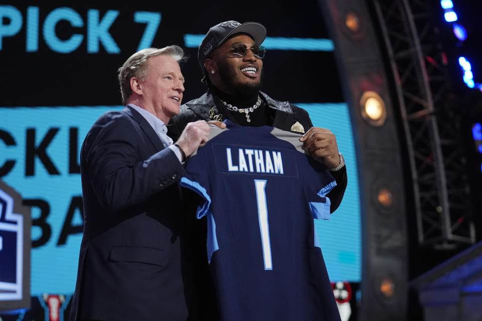 Alabama offensive lineman JC Latham poses with NFL Commissioner Roger Goodell, right, after being chosen by the Tennessee Titans with the seventh overall pick during the first round of the NFL football draft, Thursday, April 25, 2024, in Detroit. (AP Photo/Jeff Roberson)