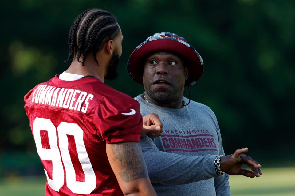 Washington Commanders defensive end Montez Sweat (90) talks with Warren Sapp, right, during minicamp in Ashburn, Virginia on June 15, 2022.