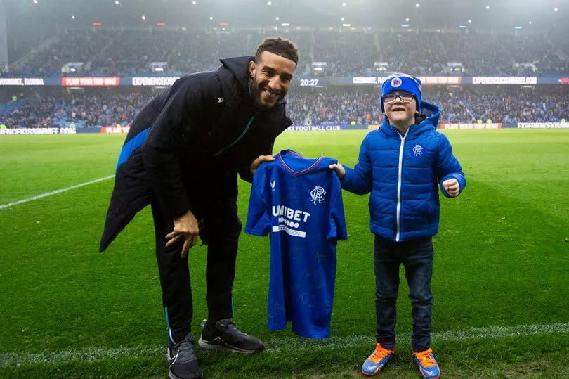 Connor Goldson gives young Rangers fan Iain Norrie (8) a signed shirt at half time during the Scottish Premiership match at Ibrox Stadium, Glasgow.