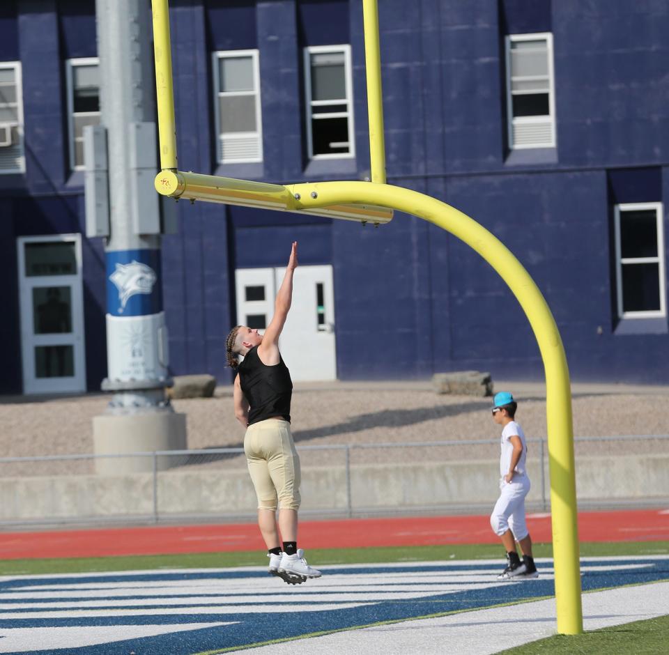 Xavier Moreau of Derry tries to touch the crossbar before Tuesday's practice at the annual UNH Youth Football Camp this week at Wildcat Stadium.