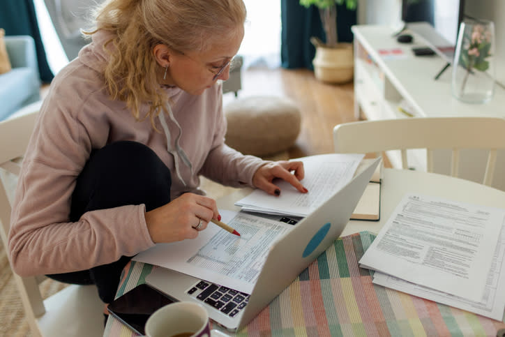 A woman reviewing her taxes after the sell of her principal residence.