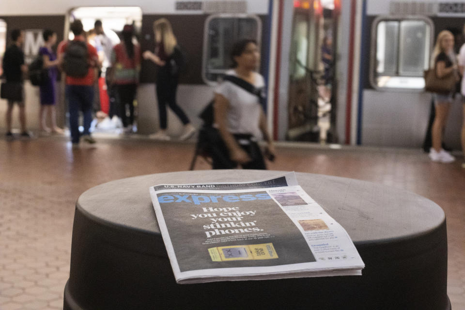 A final copy of the free commuter paper, Express, is seen at a Metro Center Station in downtown Washington, Thursday, Sept. 12, 2019. The Washington Post announced yesterday that it has decided to cease publication of its Express commuter paper, that has been handed out for free at Metro stations for 16 years. (AP Photo/Pablo Martinez Monsivais)