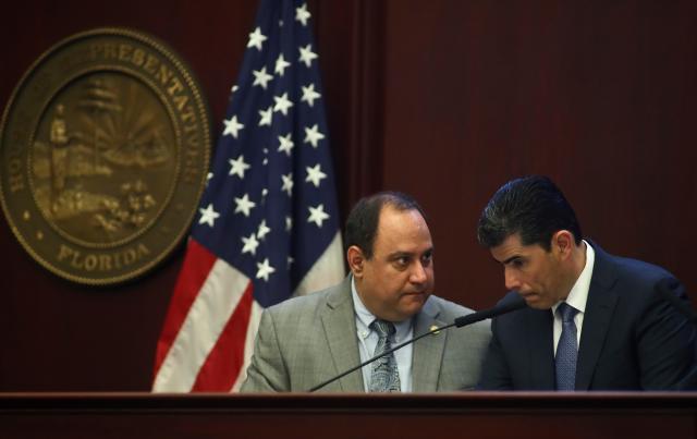 Rep. Ray Rodrigues, R-Estero and House Speaker Jose Oliva, R- Miami Lakes, confer during debate over House Bill 7089 - Voting Rights Restoration, Tuesday April 23, 2019 in the Florida House of Representatives in Tallahassee, Fla. (AP Photo/Phil Sears)