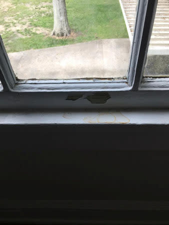 Cracked and peeling paint is seen on a windowsill of the duplex where the Price family lived on Gillis W. Long National Guard Center in Carville, Louisiana, U.S., in this undated handout photo obtained by Reuters October 2, 2018. The area tested high for lead. Coryn Price/Handout via Reuters