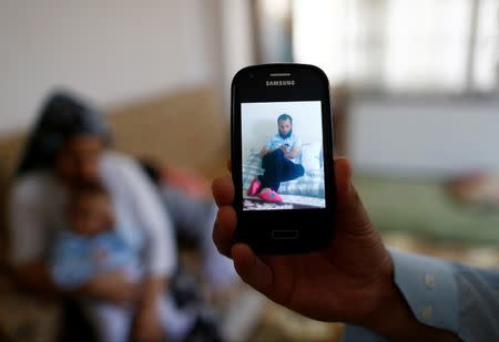 Tahir Kipcak shows photograph of his son Murat during an interview with Reuters in Istanbul, Turkey, May 31, 2016. REUTERS/Osman Orsal